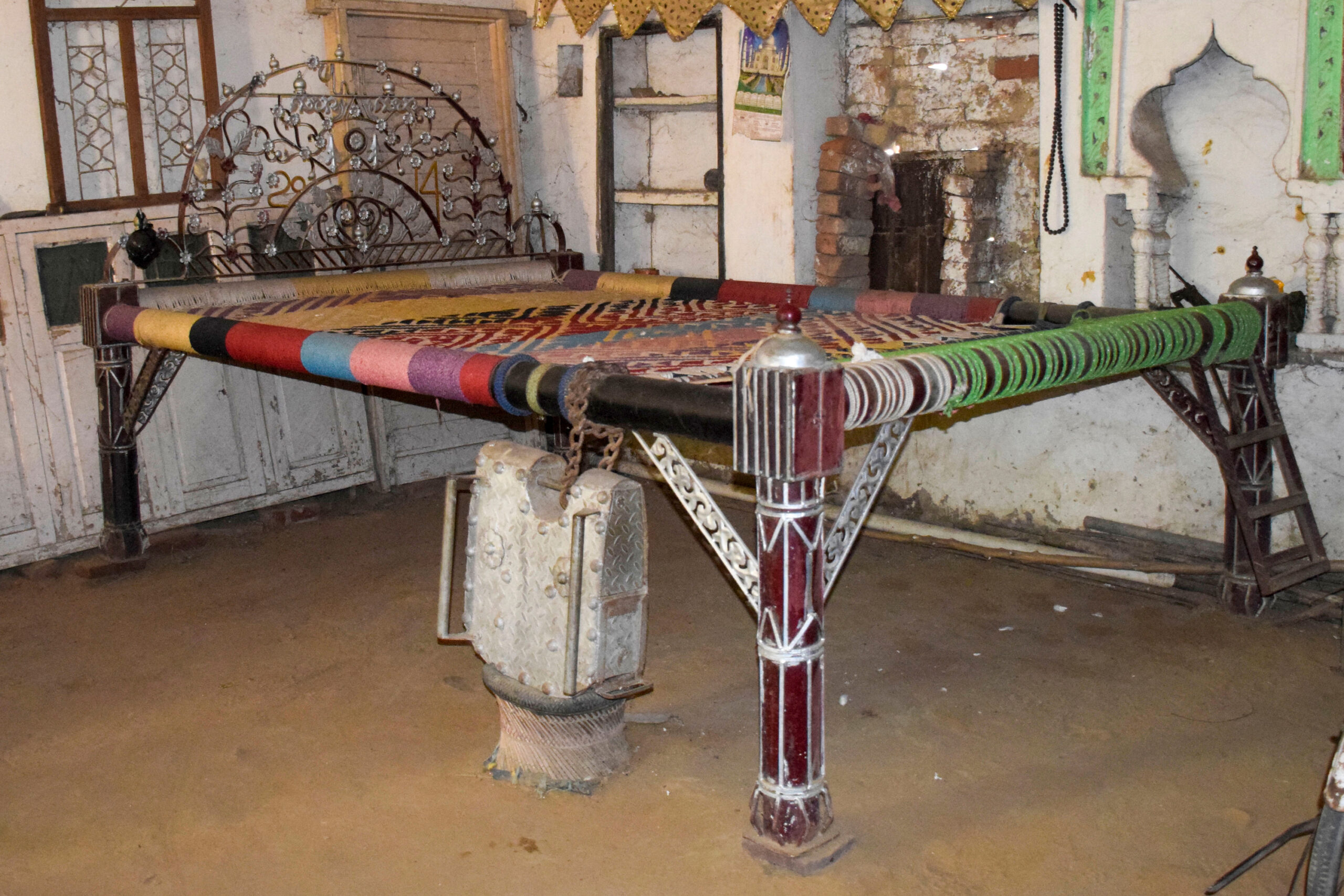 Photograph of a large wooden palang from Luhinga Kalan comissioned specially for wedding guests to sit on