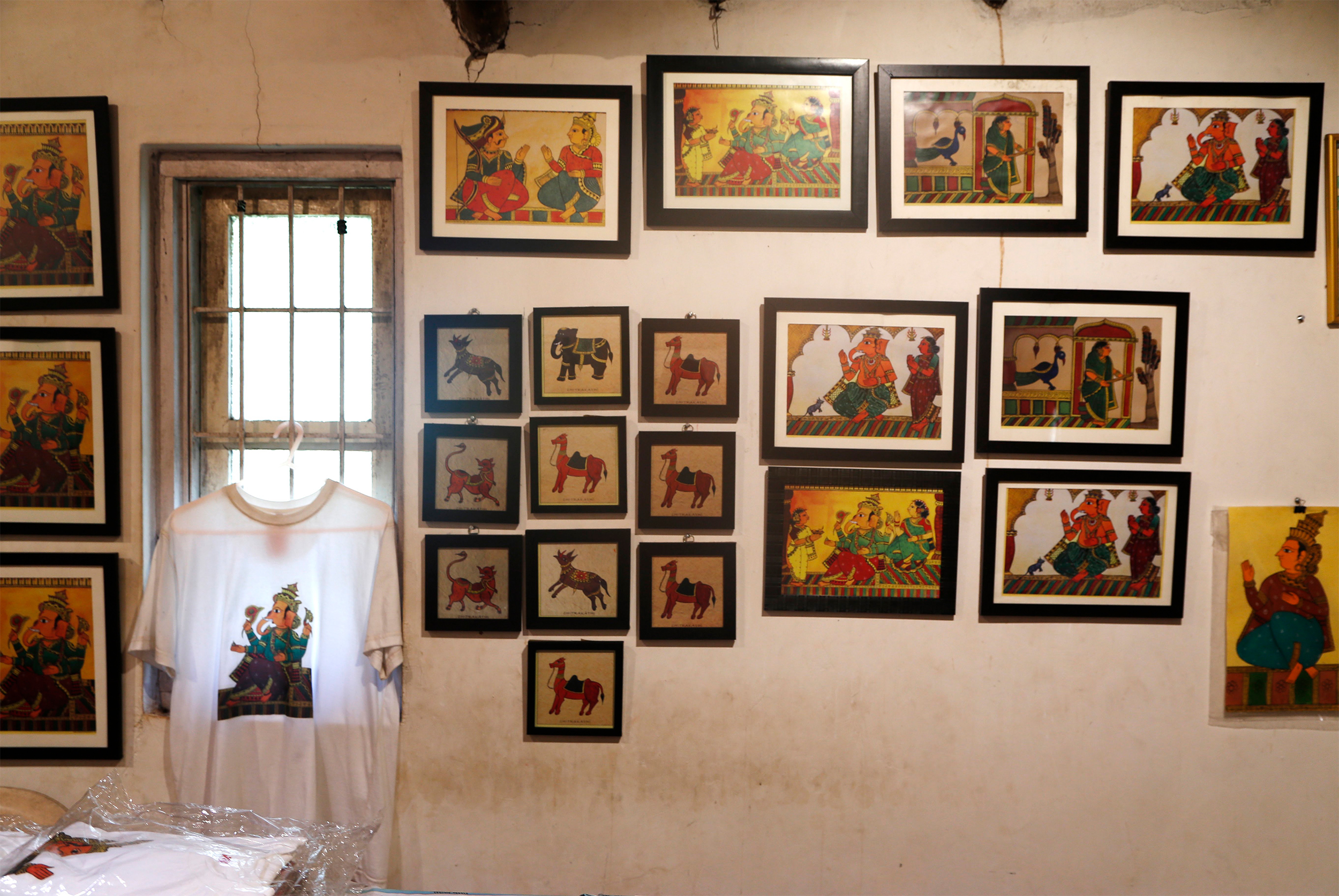 Photograph showing the installation view of some contemporary chitrakathi paintings at the Thakar Adivasi Kala Aangan Museum