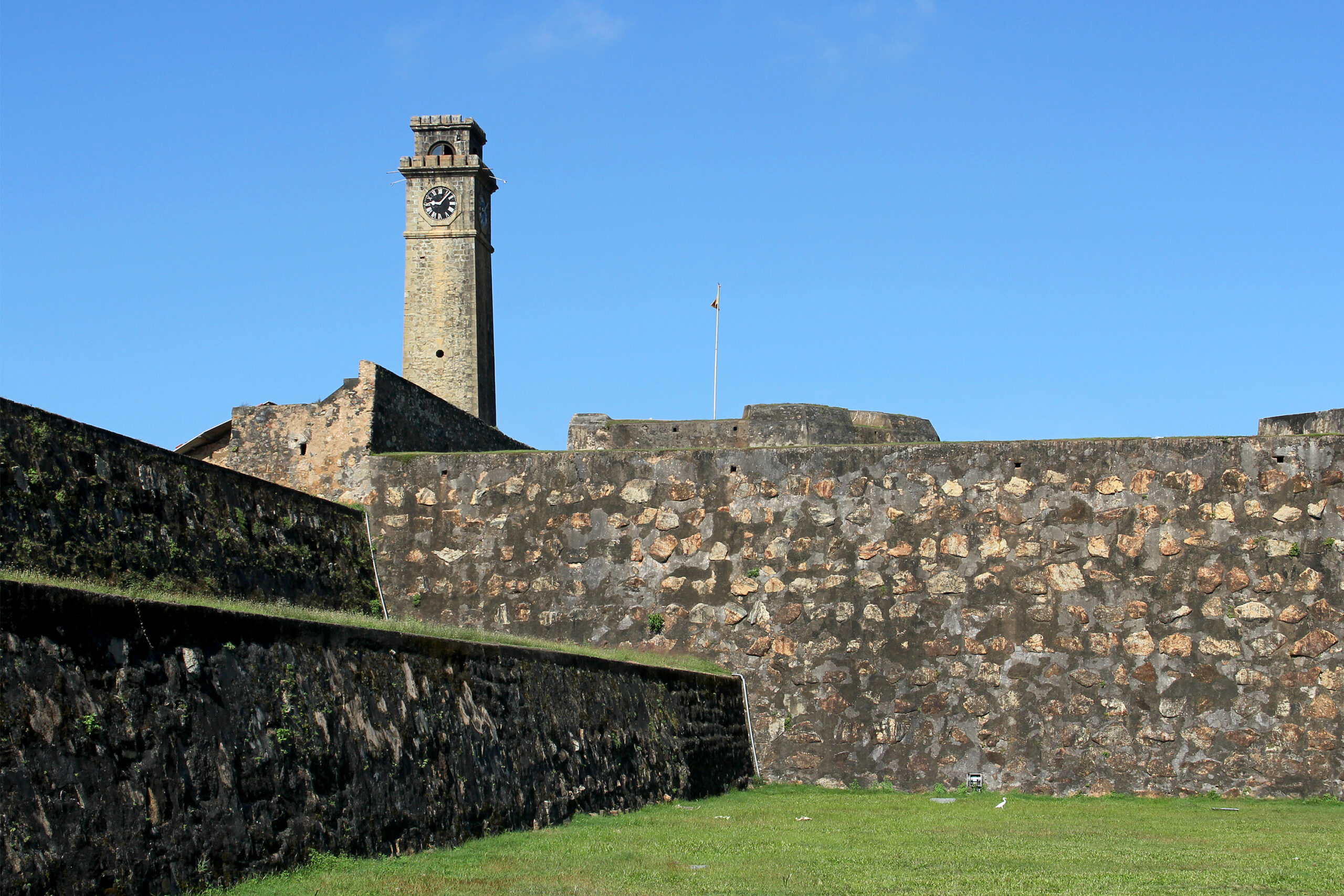 Photograph of the fortification walls at Galle Fort in Sri Lanka with the Galle Clock Tower in the backdrop