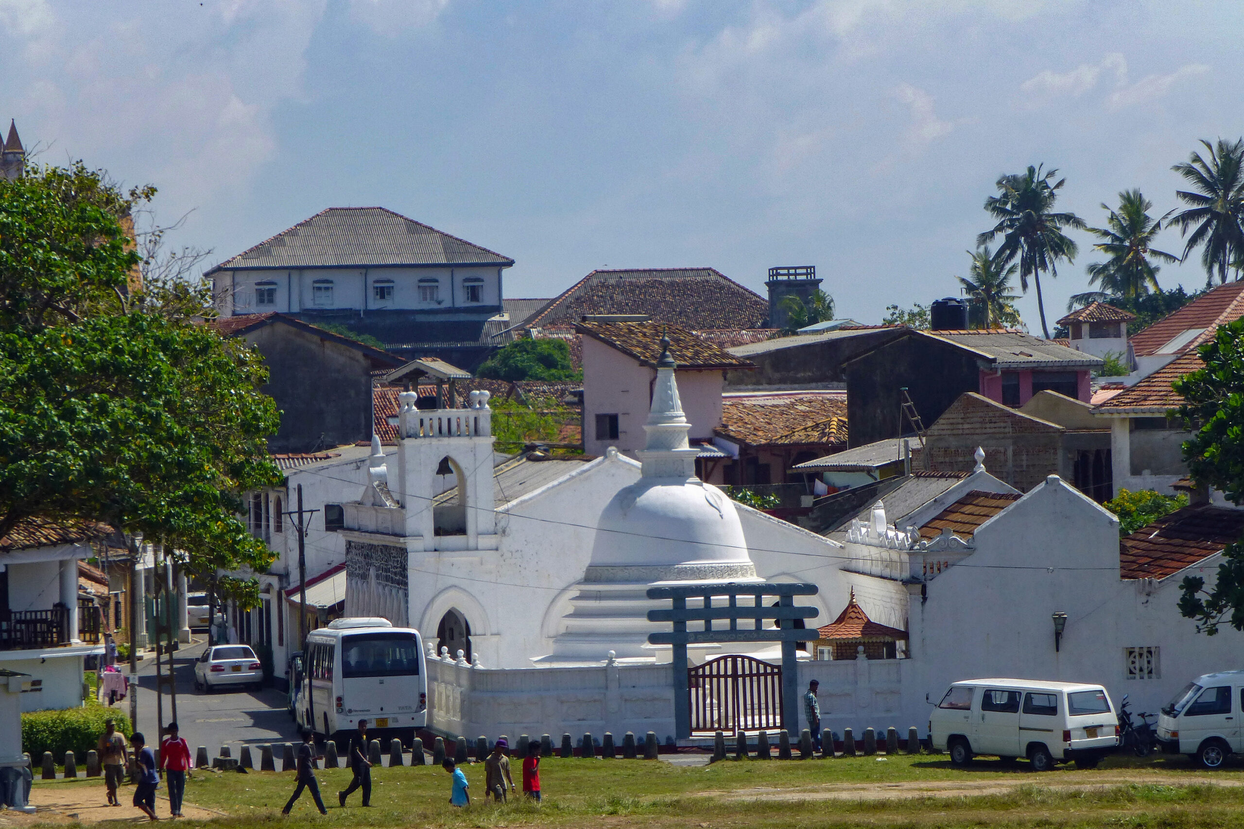 Photograph of a Buddhist stupa and houses in Galle