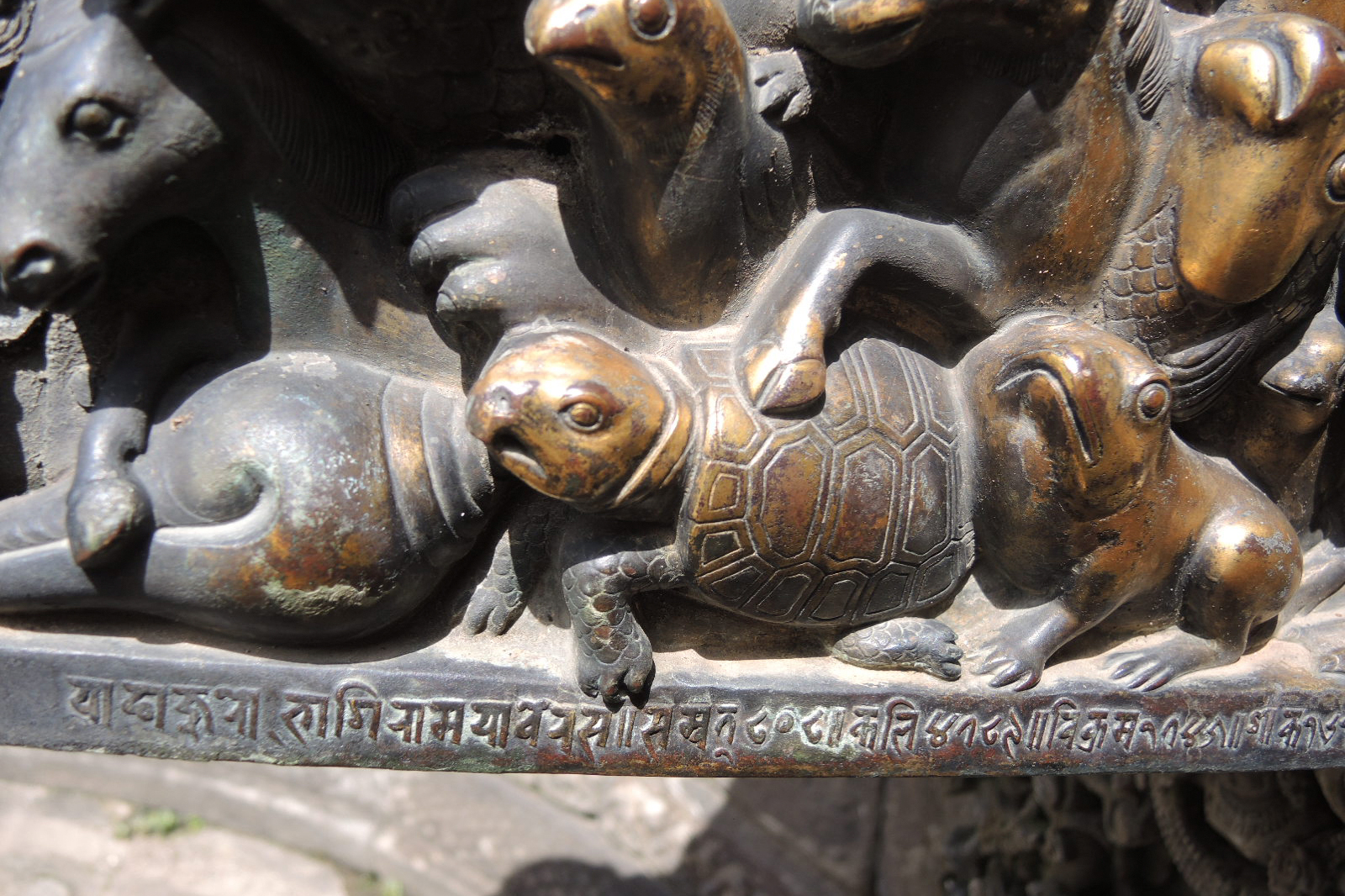 Close-up photograph of the inscription on the spout of the Thanthu Darbar hiti in Bhaktapur, Nepal