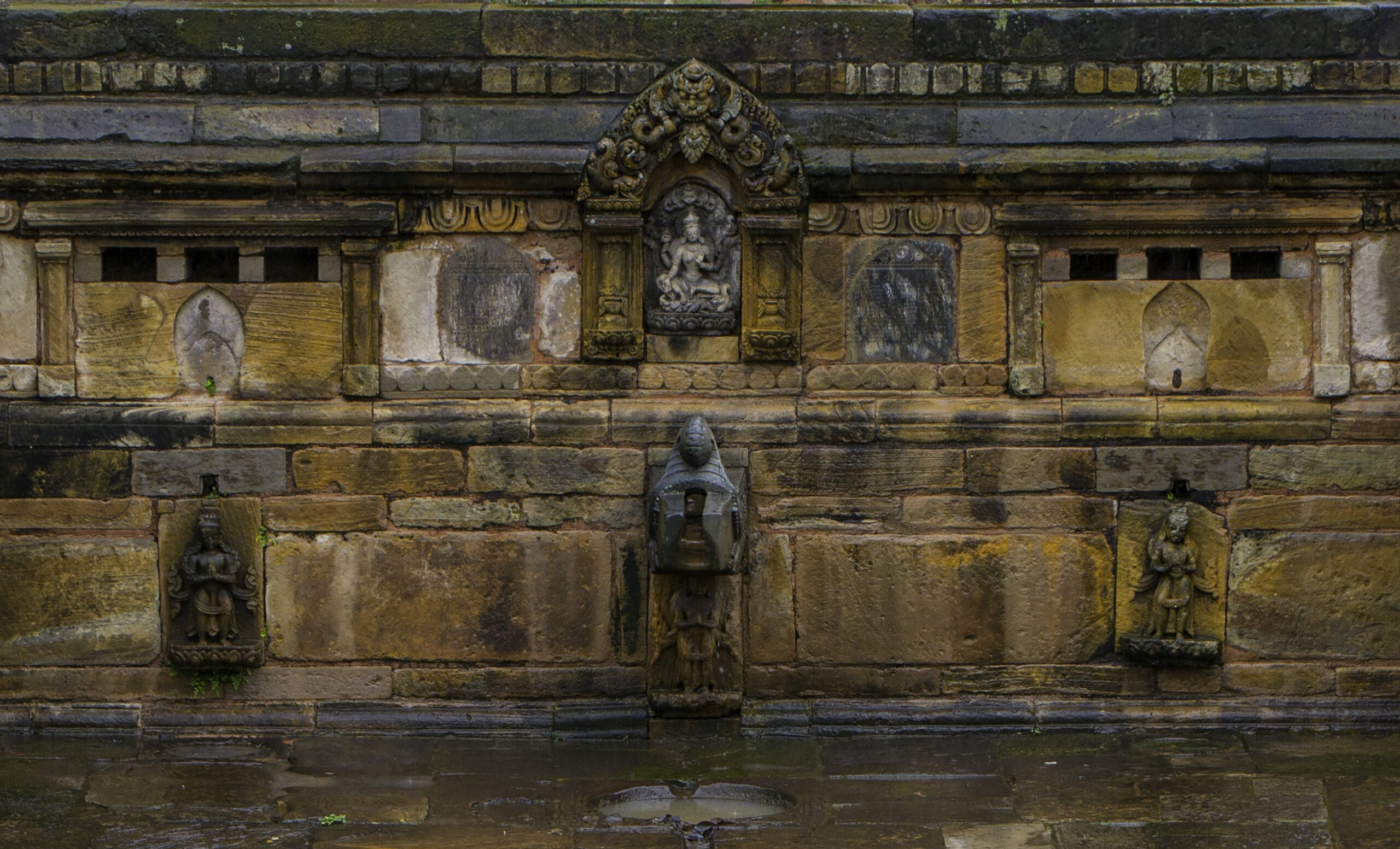 Photograph of the Bhandarkhal pokhari showing two jahru's on either side of a stone spout