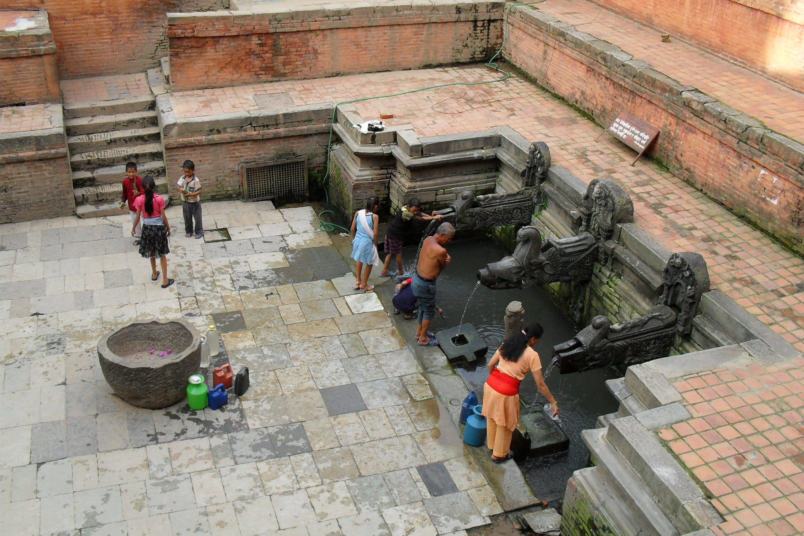 Photograph of people using the Manga hiti in Kathmandu, Nepal