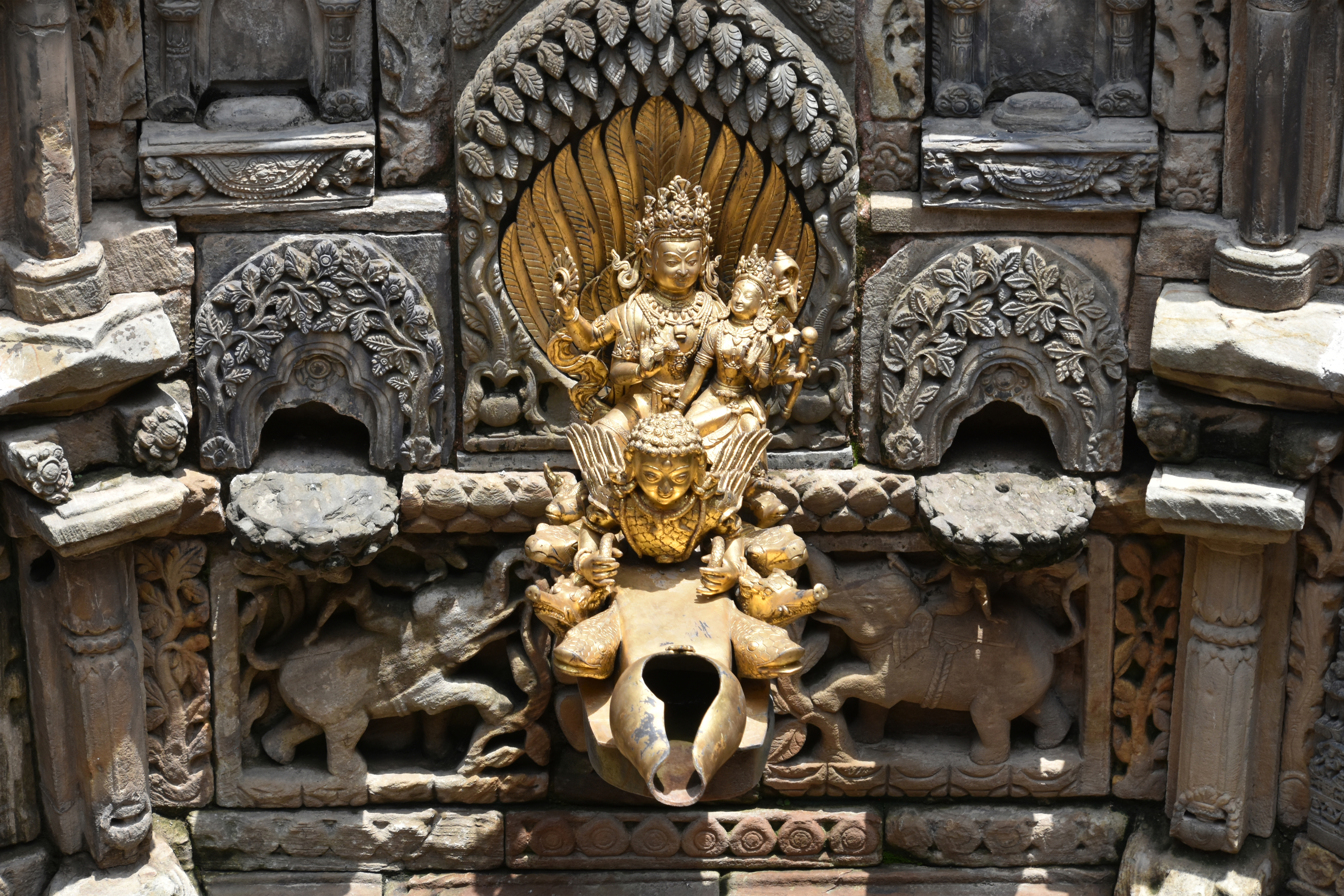 Close-up photograph of the spout of the Tusha hiti showing Vishnu and Lakshmi riding on top of Garuda